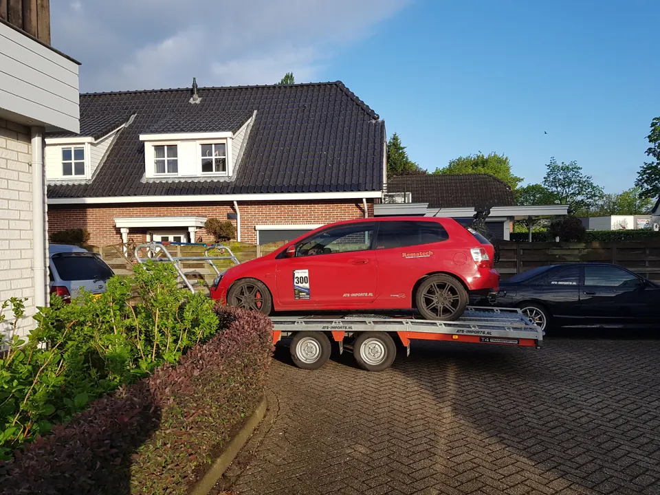 Rode sporthatchback op trailer